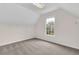 Attic bedroom featuring neutral carpeting and a window view at 2111 Fernbank Way, Dacula, GA 30019