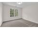 Bright bedroom with neutral carpet and a large window overlooking a green view at 2111 Fernbank Way, Dacula, GA 30019