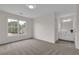 Spacious carpeted bedroom with an ensuite bathroom and a window view at 2111 Fernbank Way, Dacula, GA 30019