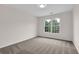 Cozy carpeted bedroom featuring a well-lit window for natural light at 2111 Fernbank Way, Dacula, GA 30019