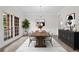 Bright dining room features modern chandelier, natural light, and access to outdoor views at 2111 Fernbank Way, Dacula, GA 30019