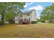 Spacious home with an outdoor deck overlooking a vast yard adorned with mature trees and impeccable landscaping at 2111 Fernbank Way, Dacula, GA 30019