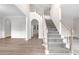 Elegant foyer featuring a grand staircase, hardwood floors, and neutral tones, creating a welcoming ambiance at 2111 Fernbank Way, Dacula, GA 30019