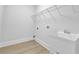 Clean and bright laundry room with white trim, white utility sink, and vinyl flooring at 2111 Fernbank Way, Dacula, GA 30019