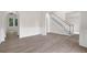 Spacious living area with hardwood floors and neutral walls, flowing seamlessly into other rooms at 2111 Fernbank Way, Dacula, GA 30019