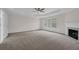 Expansive primary bedroom featuring a tray ceiling and cozy fireplace at 2111 Fernbank Way, Dacula, GA 30019