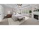Comfortable main bedroom features a fireplace, ceiling fan, neutral paint, and large windows at 2111 Fernbank Way, Dacula, GA 30019