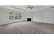 Spacious carpeted primary bedroom with a ceiling fan and fireplace feature at 2111 Fernbank Way, Dacula, GA 30019