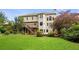 Expansive backyard featuring a well-maintained lawn, mature trees, and a deck accessible from the home at 249 Thorncliff Lndg, Acworth, GA 30101