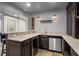 Basement bar area includes granite countertops, dark cabinetry, and a wine cellar at 249 Thorncliff Lndg, Acworth, GA 30101