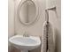 Powder room with a sleek pedestal sink, framed mirror and decorative hand towel at 249 Thorncliff Lndg, Acworth, GA 30101