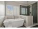 Luxurious bathroom with a freestanding tub, glass shower, and bright light at 249 Thorncliff Lndg, Acworth, GA 30101