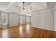 A large bedroom boasts a tray ceiling, hardwood floors, neutral walls and lots of sunlight for relaxing at 249 Thorncliff Lndg, Acworth, GA 30101