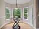 Breakfast nook with large windows and glass table next to access door to the deck at 249 Thorncliff Lndg, Acworth, GA 30101