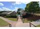 Community pool with a covered pavilion, manicured landscaping, and a walkway at 249 Thorncliff Lndg, Acworth, GA 30101