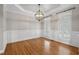 Formal dining room with hardwood floors, decorative wainscoting, and a stylish chandelier at 249 Thorncliff Lndg, Acworth, GA 30101