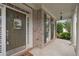 Inviting front porch with brick facade, decorative door hanging, and elegant column supports at 249 Thorncliff Lndg, Acworth, GA 30101
