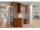 View of kitchen features a workstation desk and built-in double ovens adjacent to the living room at 249 Thorncliff Lndg, Acworth, GA 30101
