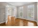 Elegant living room with hardwood floors, decorative molding, and bright windows with shutters at 249 Thorncliff Lndg, Acworth, GA 30101