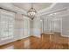 Spacious open room with hardwood floors, wainscoting, and white french doors to another room at 249 Thorncliff Lndg, Acworth, GA 30101