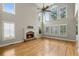 Bright living room with soaring ceilings, a stone fireplace, and large windows with plantation shutters at 249 Thorncliff Lndg, Acworth, GA 30101