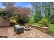 Backyard brick patio featuring an outdoor fire pit and lovely landscaping at 249 Thorncliff Lndg, Acworth, GA 30101