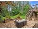 Spacious backyard patio with a fire pit, outdoor seating, and stairs to deck at 249 Thorncliff Lndg, Acworth, GA 30101