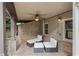 Relaxing covered patio seating area with brick flooring and ceiling fan at 249 Thorncliff Lndg, Acworth, GA 30101