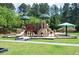 Community playground with multiple slides, climbing areas, and shaded picnic tables at 249 Thorncliff Lndg, Acworth, GA 30101