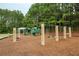 Community playground featuring swings, slides, and climbing structures in a wooded setting at 249 Thorncliff Lndg, Acworth, GA 30101