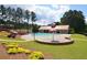 Community pool area featuring a mushroom water feature, slide, and well-maintained landscaping at 249 Thorncliff Lndg, Acworth, GA 30101