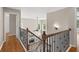 Staircase view looking down at the living room with fireplace, wood floors, and vaulted ceilings at 249 Thorncliff Lndg, Acworth, GA 30101