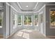 Sunroom with large windows overlooking the wooded backyard and a door to the outside deck at 249 Thorncliff Lndg, Acworth, GA 30101