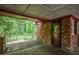 Charming back porch with brick accents and a view of the lush greenery, ideal for outdoor relaxation at 3082 Corbin Ave, Decatur, GA 30034