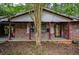 Charming brick home with a covered front porch and mature trees, creating a welcoming entry at 3082 Corbin Ave, Decatur, GA 30034