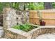 A backyard pond framed with stonework and greenery adds charm and tranquility at 50 Dartmouth Ave, Avondale Estates, GA 30002