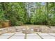 Inviting stone fire pit area in a serene backyard setting with surrounding benches at 50 Dartmouth Ave, Avondale Estates, GA 30002