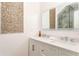 Bathroom with double sinks, white cabinets, and a decorative vanity at 50 Dartmouth Ave, Avondale Estates, GA 30002