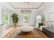 Bright bedroom featuring a large decorative rug, modern lighting, and a comfortable lounge area at 50 Dartmouth Ave, Avondale Estates, GA 30002