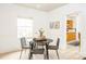 Cozy breakfast nook features modern chairs, a round table, and view to the kitchen at 50 Dartmouth Ave, Avondale Estates, GA 30002