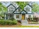 Charming Tudor-style home featuring a unique exterior, inviting front porch, and well-manicured landscaping at 50 Dartmouth Ave, Avondale Estates, GA 30002