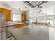 Bright kitchen features a large island with cooktop, stainless steel appliances, and ample counter space at 50 Dartmouth Ave, Avondale Estates, GA 30002