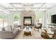 Cozy living room featuring a stone fireplace, comfortable seating, and abundant natural light, ideal for relaxation at 50 Dartmouth Ave, Avondale Estates, GA 30002