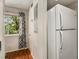 Kitchen area with window and white refrigerator appliance at 1418 Foxhall Se Ln # 18, Atlanta, GA 30316