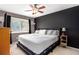 Comfortable main bedroom with a large bed, natural light, and a dark accent wall at 1418 Foxhall Se Ln # 18, Atlanta, GA 30316