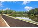 A scenic pond is lined with trees and a new walkway under a bright blue sky at 1418 Foxhall Se Ln # 18, Atlanta, GA 30316