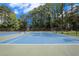 Tennis courts with blue and green surface surrounded by trees and greenery at 1418 Foxhall Se Ln # 18, Atlanta, GA 30316