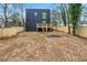 View of the black house from the backyard with a new, wooden fence at 2402 Lynn Iris Dr, Decatur, GA 30032