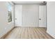 Bedroom with wood floors, two doors and a view to the backyard at 2402 Lynn Iris Dr, Decatur, GA 30032