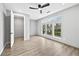 Bright bedroom with wood floors, a ceiling fan, large windows, and an attached closet at 2402 Lynn Iris Dr, Decatur, GA 30032